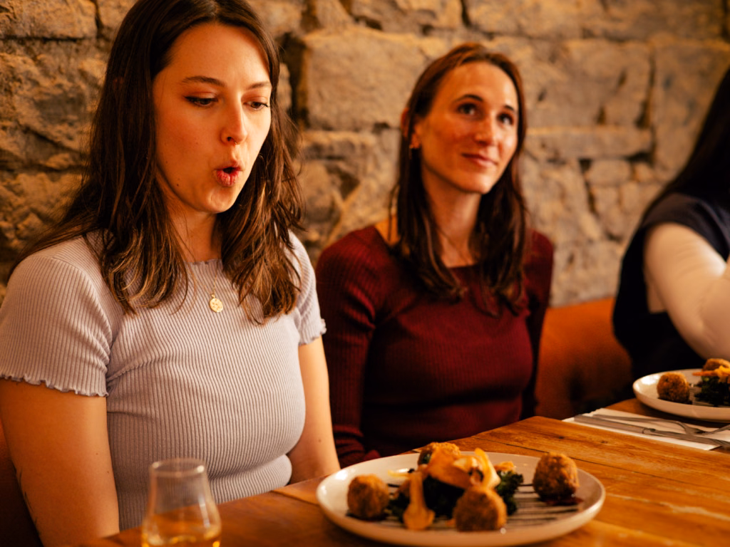 A guest enjoying haggis bonbons with whisky marmalade