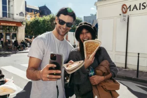 people_taking_a_photo_with_a_crepe_from_Breizh_Cafe_Paris