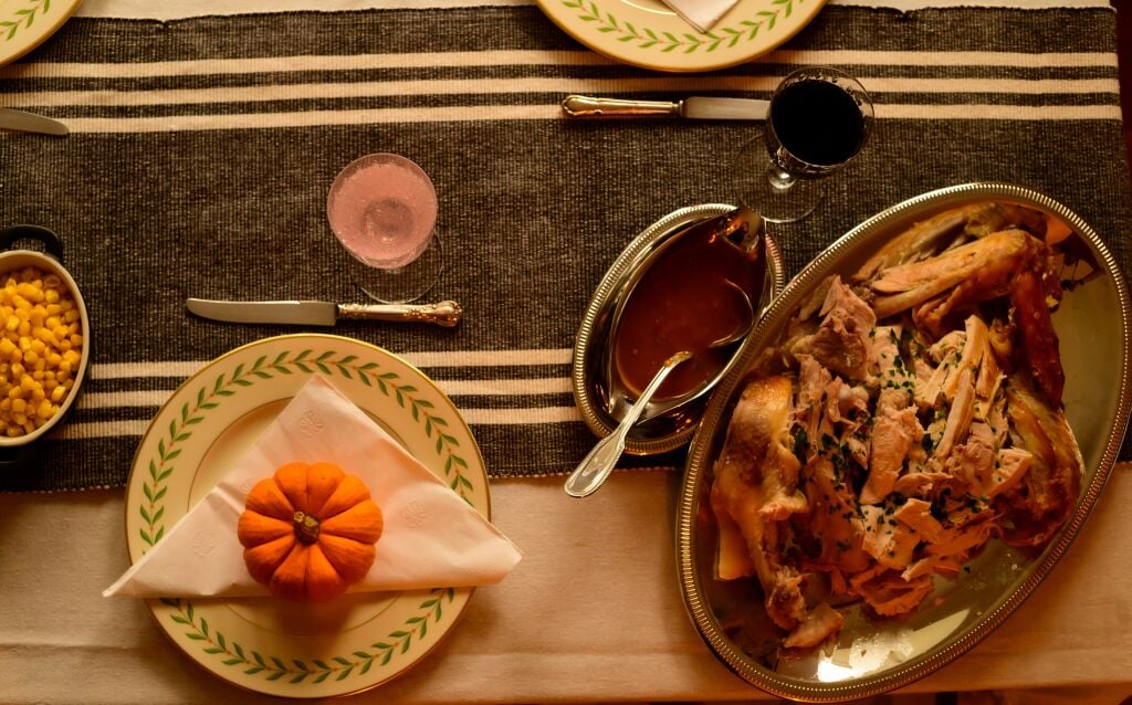 a thanksgiving dinner with cut up turkey on a serving plate