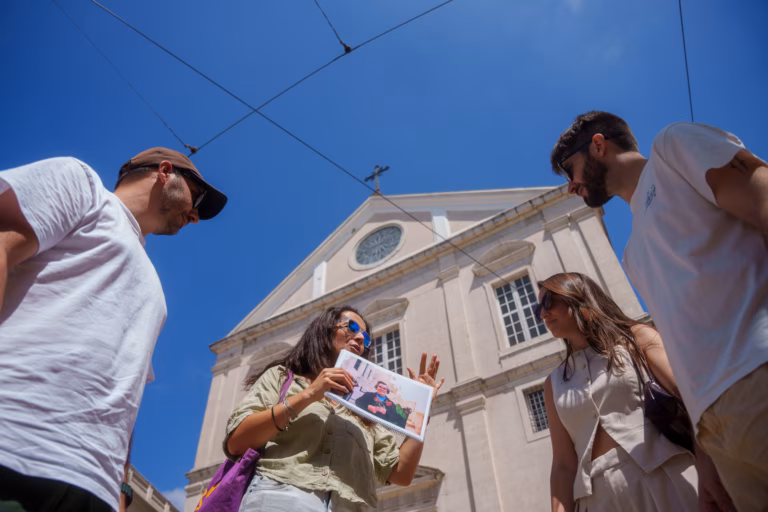 Guide explaining something outside São Roque church in Lisbon.